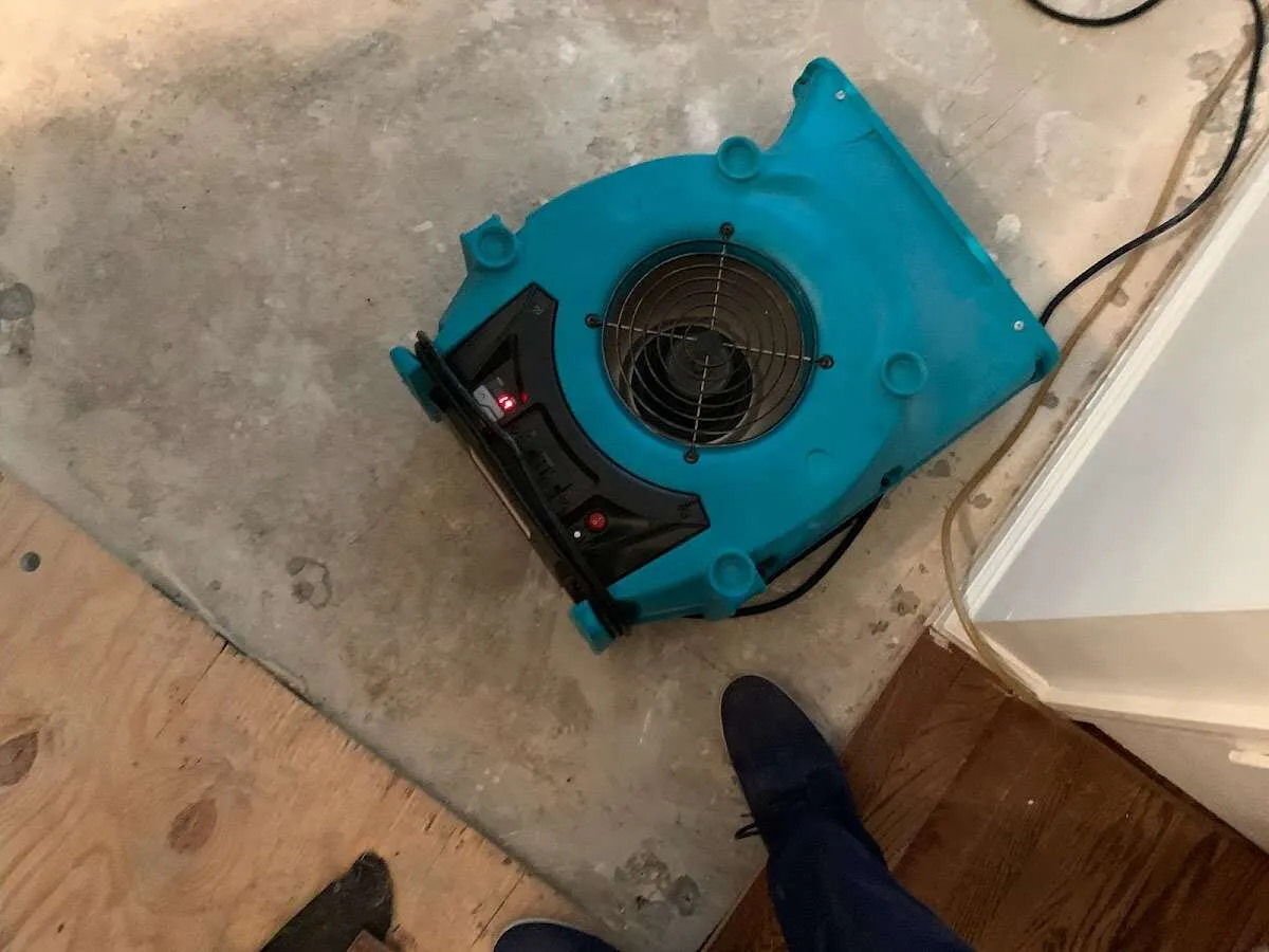 Air mover drying subfloor during Commercial Water Damage Restoration in Wyoming